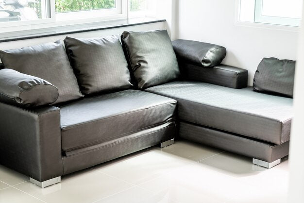 Modern  sofa bed in a bright room with large cushions.