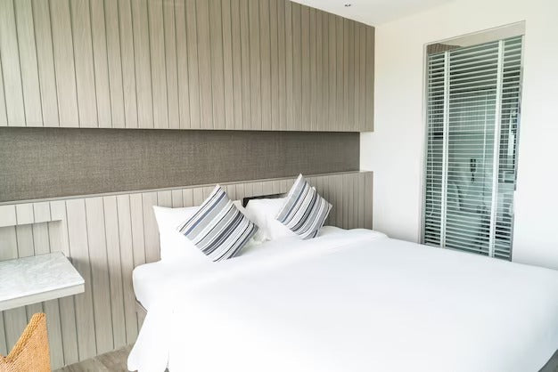 Modern bedroom with overbed storage cabinets above the bed.