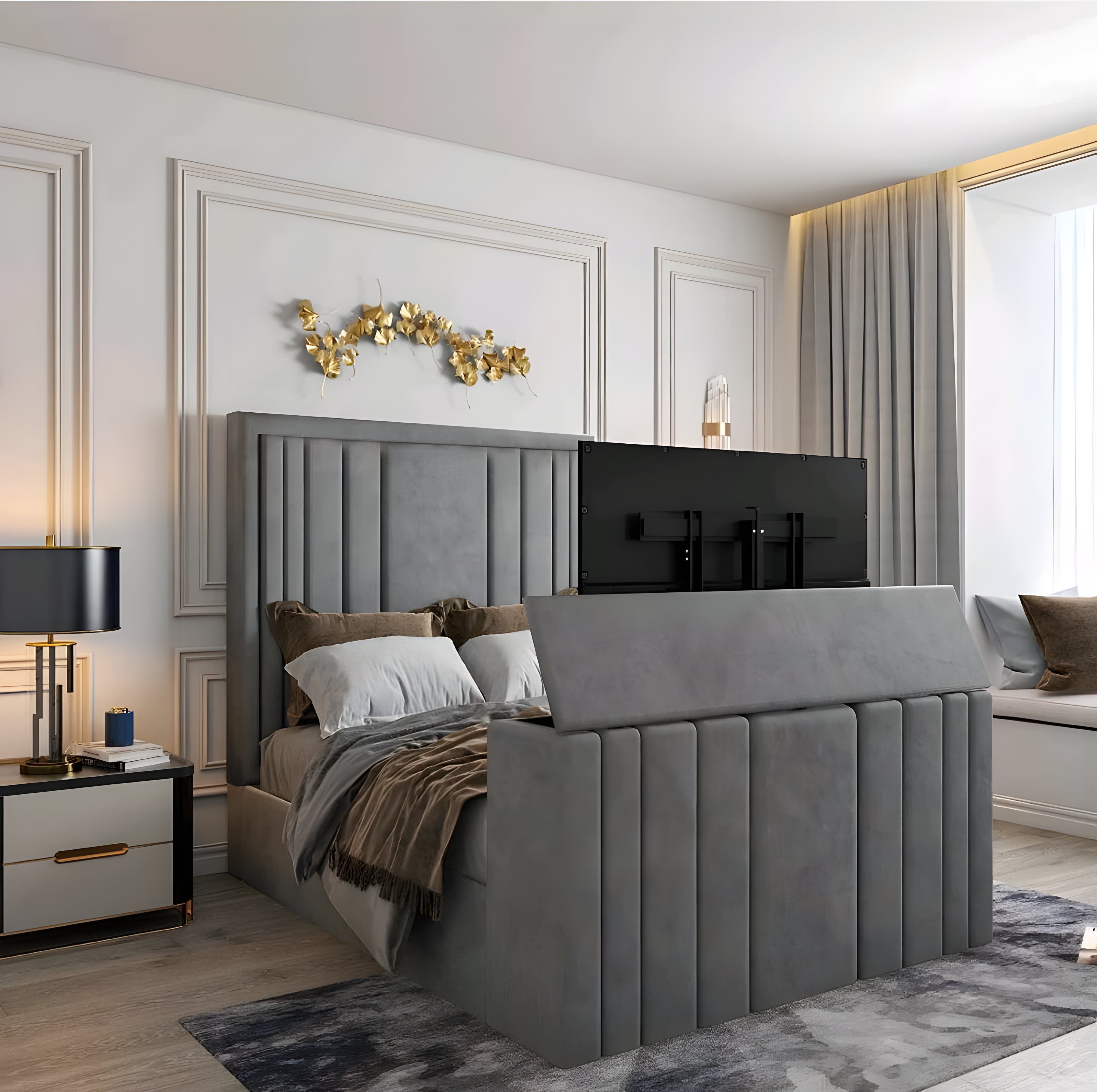 A modern bedroom with a gray upholstered smart bed and a partially extended TV from the footboard.