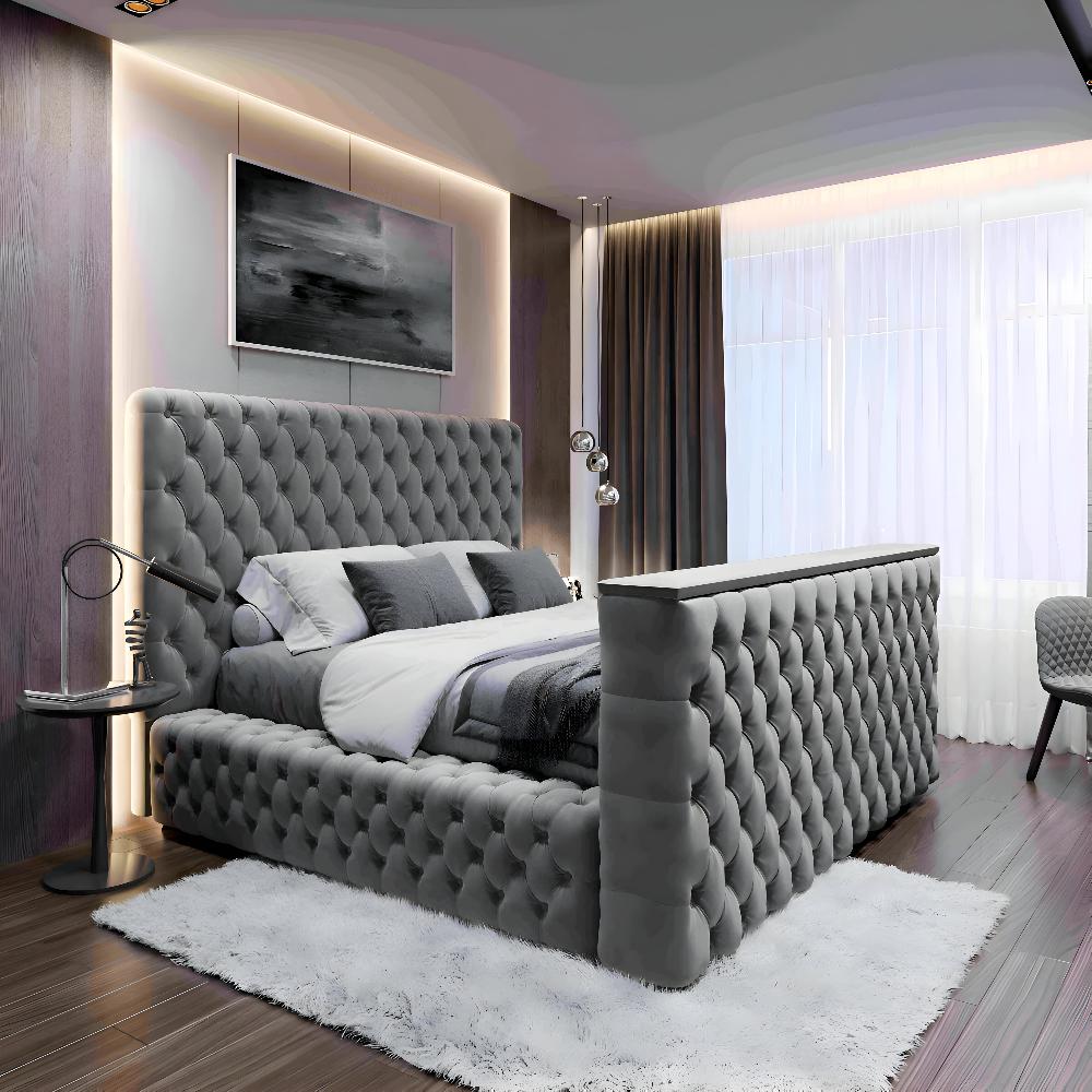 Luxurious gray tufted TV ottoman bed in a modern bedroom with gray and white bedding.