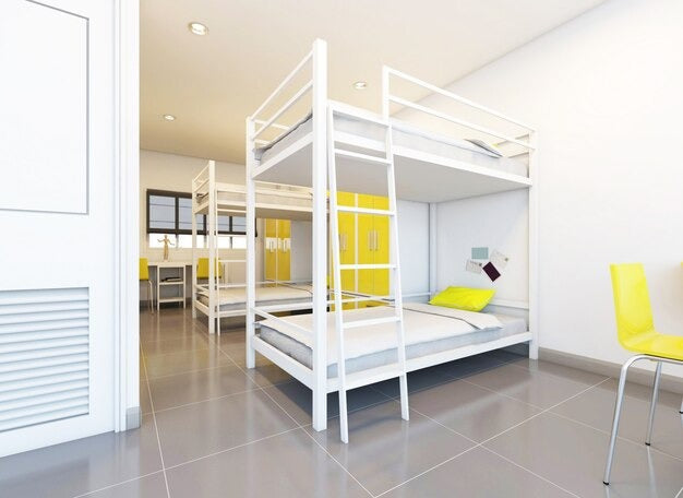 Modern bedroom with white triple bunk beds, yellow lockers, and a white desk.