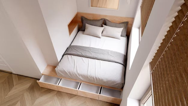 Top view of a wooden bed with storage drawers in a modern room.