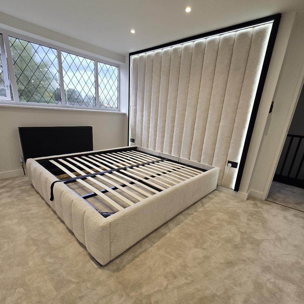 A bedroom with a light-colored Modern Upholstered Wall Panel Bed with LED Back light and a large backlit headboard.

