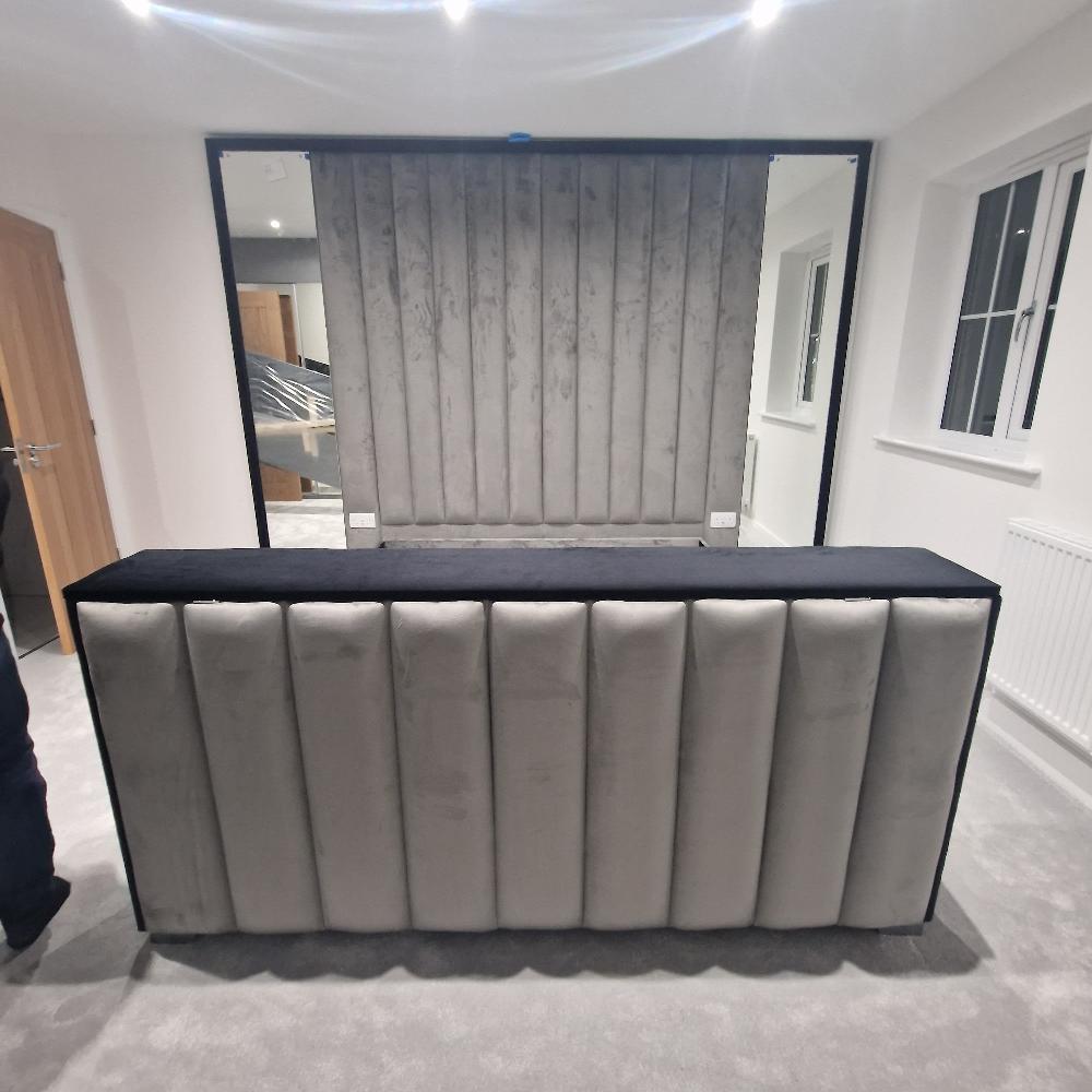 Modern The Enzo bespoke tv panel bed with large padded furniture and wall panels upholstered in light gray fabric.