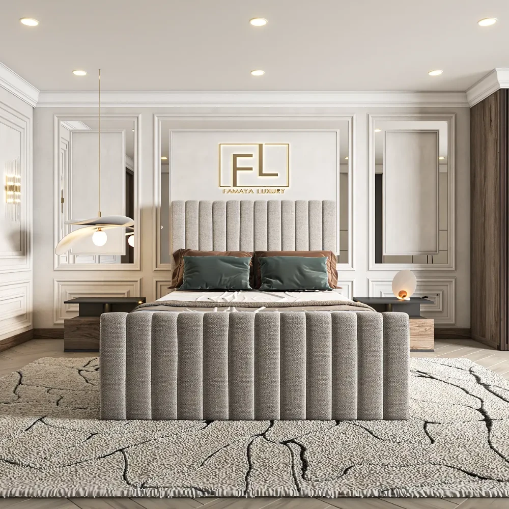 The image features The Lumiere Lined Bed Frame in a luxurious bedroom. A large upholstered bed with a tall gray headboard and footboard is dressed in white linens and dark green pillows. Modern bedside tables with spherical lamps flank the bed. A contemporary pendant light hangs above, and the walls showcase panel molding with sconces. A large "FL" logo for "FAMAYA LUXURY" is mounted above the headboard, and a textured off-white rug with dark veining covers the floor.
