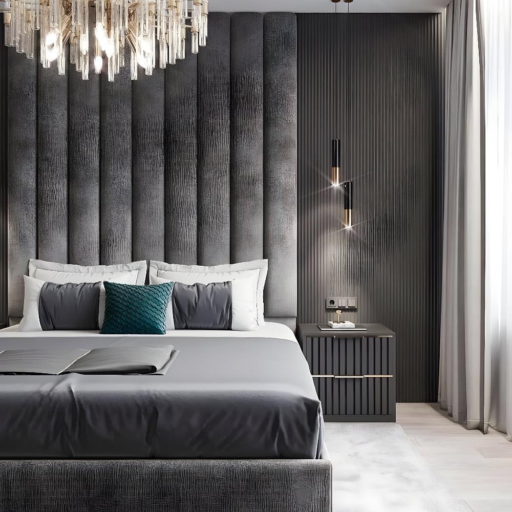 Contemporary bedroom with a gray upholstered steel aku panel bed, textured accent pillow, elegant chandelier, and modern pendant light.

