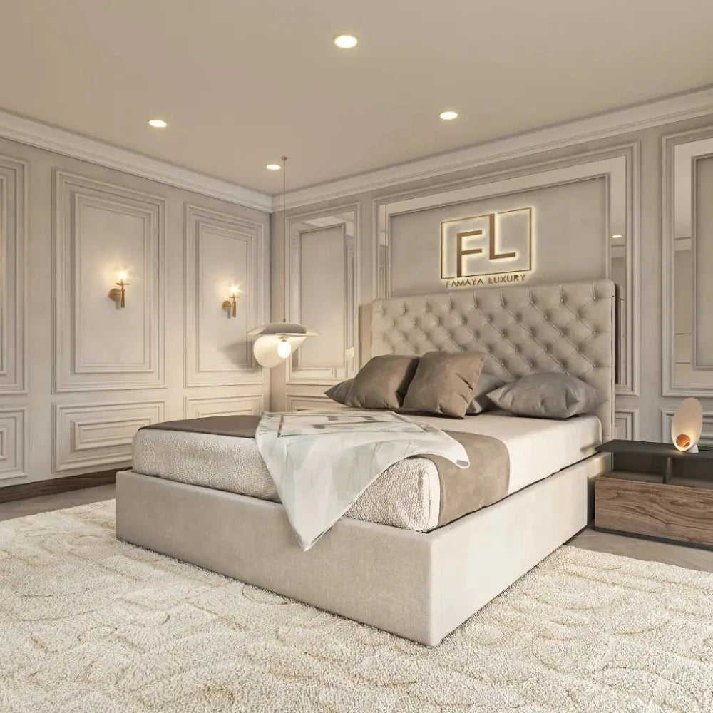 The image showcases a luxurious bedroom with a beige upholstered bed featuring a tufted headboard. Neatly arranged pillows and a white throw enhance the bed's elegance. A plush carpet complements the room’s soft tones, while modern lamps and paneled walls add sophistication. Above the bed, a golden, backlit "FL" logo completes the opulent look—highlighting The Valencia Bed Frame.
