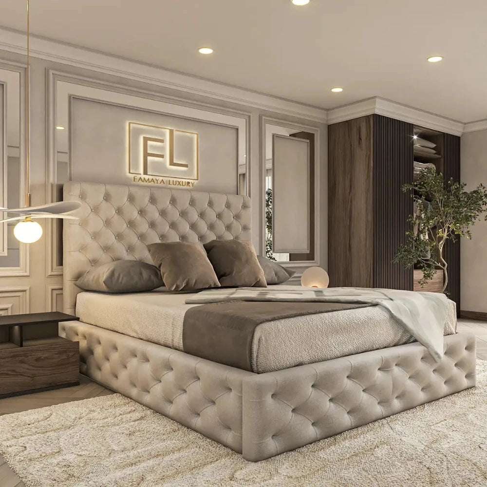 The image displays a luxurious bedroom featuring a plush, light grey tufted bed frame adorned with grey and beige bedding. Elegant wall paneling and soft ambient lighting, including two wall sconces and a pendant lamp, enhance the room's sophistication. A wooden nightstand with a modern lamp completes the refined look, beautifully showcasing The Valencia Bed Frame.